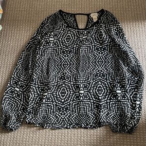 Sheer long-sleeve black and white blouse.